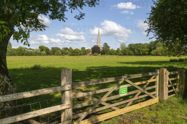 Conservation Area gate view over meadows to Salisbury cathedral church, Salisbury, Wiltshire, England, UK