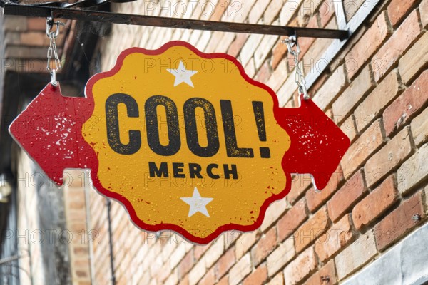 Cool! Merch shop sign fixed to wall, Salisbury, Wiltshire, England, UK