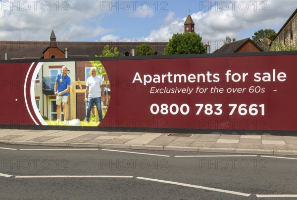 Apartments for sale for over 60s advertising hoarding, Churchill Retirement Living, Salisbury, Wiltshire, England, UK