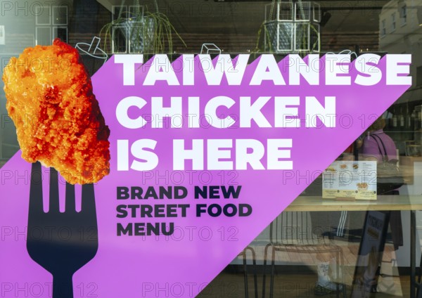 Taiwanese Chicken is here notice in shop window, Salisbury, Wiltshire, England, UK