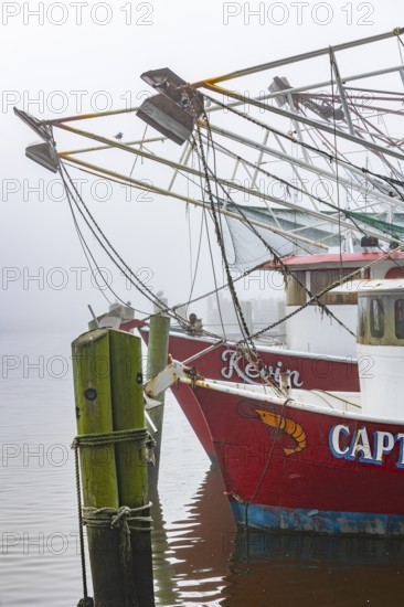 Commercial shrimp boats at the dock in the commercial area of the Biloxi Small Craft Harbor in Biloxi, Mississippi
