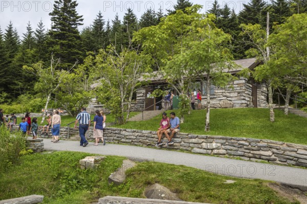 Park guests resting on stone wall outside the store at Clingman's Dome in the Great Smoky Mountains National Park