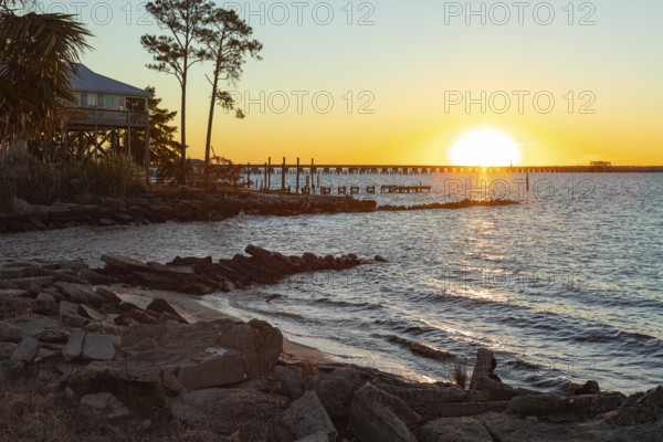 Sunset over the railroad bridge across Bay of Saint Louis from Henderson Point in Pass Christian, Mississippi