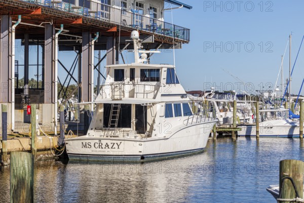 Private fishing boat at the dock below McElroy's Harbor House restaurant at the Biloxi Small Craft Harbor in Biloxi, MS