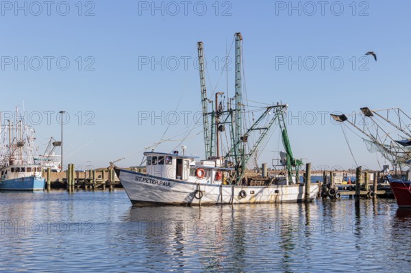 Commercial fishing boat St. Peter. Paul pulling into the dock in the commercial section of the Biloxi Small Craft Harbor in Biloxi, MS
