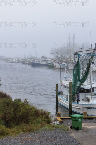 Commercial fishing boats in the harbor at Ocean Springs, Mississippi on a foggy morning