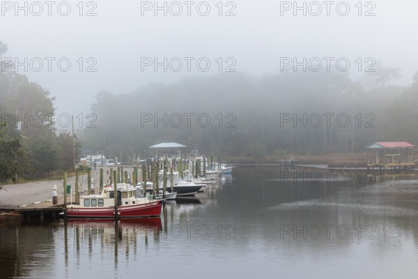 Private fishing boats in the harbor at Ocean Springs, Mississippi on a foggy morning