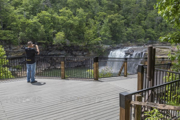Man photographing the Little River Falls from the observation deck in Little River Canyon Falls Park near Ft. Payne, Alabama