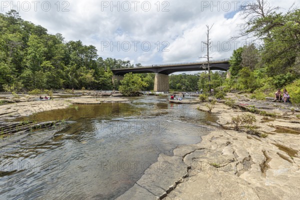 People playing on the rocks under the Little River Falls Bridge in Little River Canyon Falls Park near Ft. Payne, Alabama