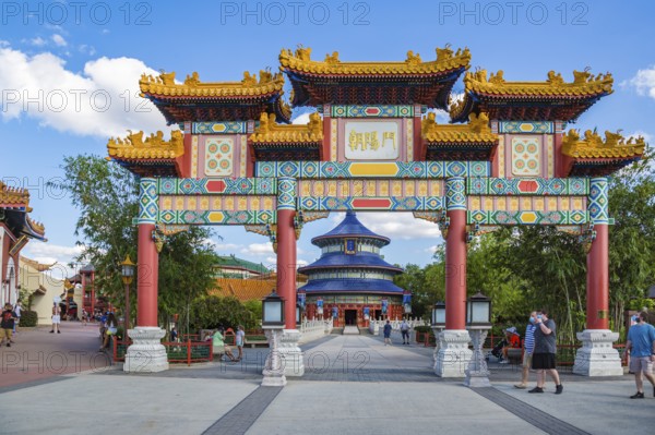 Masked park guests near the entrance to the China area of Epcot at Walt Disney World in Orlando, Florida