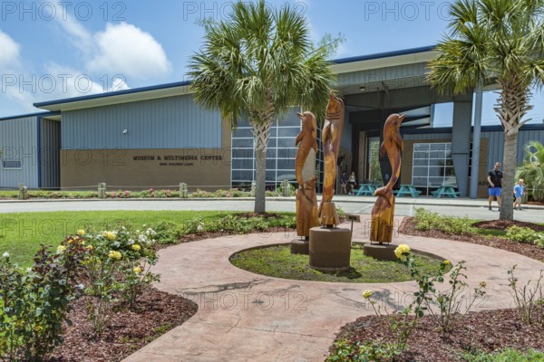Carved wooden dolphins outside the Museum and Multimedia center at Ocean Adventures Marine Park in Gulfport, Mississippi