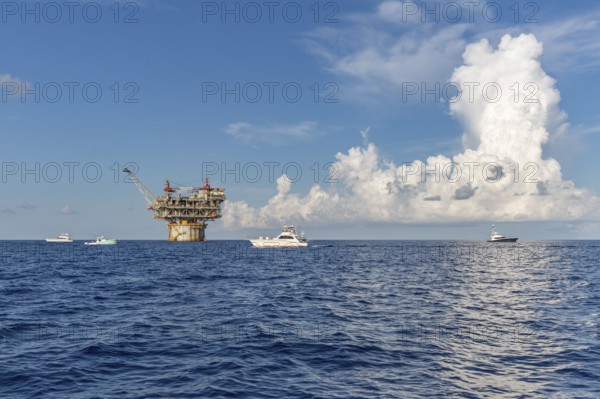 Offshore private fishing boats near an offshore petroleum drilling rig in the Gulf of Mexico