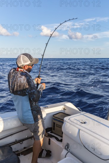 Offshore fisherman reeling in a fish in the Gulf of Mexico