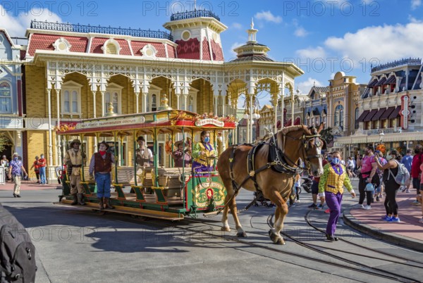 Horse pulling trolley car with Disney characters down Main Street in the Magic Kingdom at Walt Disney World, Orlando, Florida