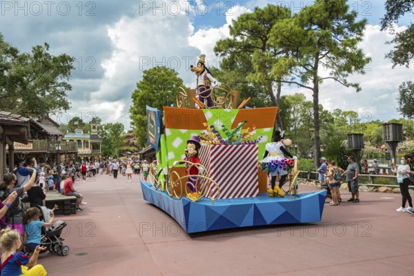 Disney characters riding on float during parade through the Frontierland area of Magic Kingdom at Walt Disney World, Orlando, Florida
