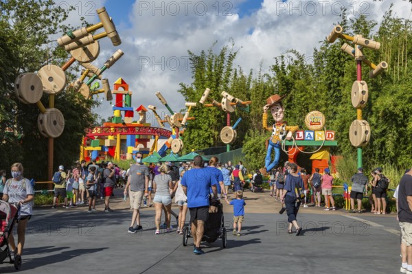 Masked park guests in Toy Story Land in Disney's Hollywood Studios theme park
