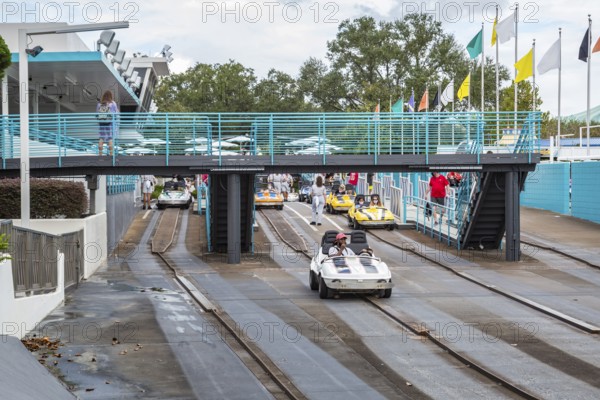 Black man and son riding a car in the Tomorrowland Speedway at the Tomorrow land area of the Magic Kingdom at Walt Disney World, Orlando, Florida