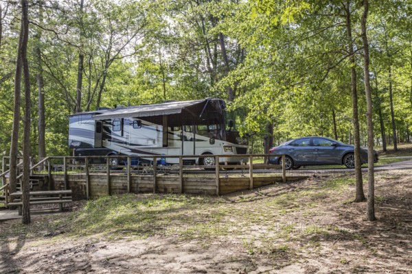 Motorhome parked in a campsite on the bank of the lake at Little Black Creek campground near Lumberton, Mississippi