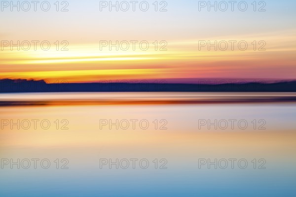 Motion blurred abstract lake at sunset background or wallpaper