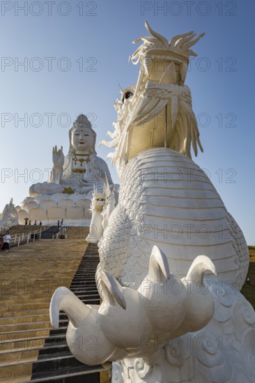 Chinese dragons line the steps up to the Guan Yin (Goddess of Mercy) statue at Wat Huay Pla Kang Temple in Chiang Rai province of Northern Thailand