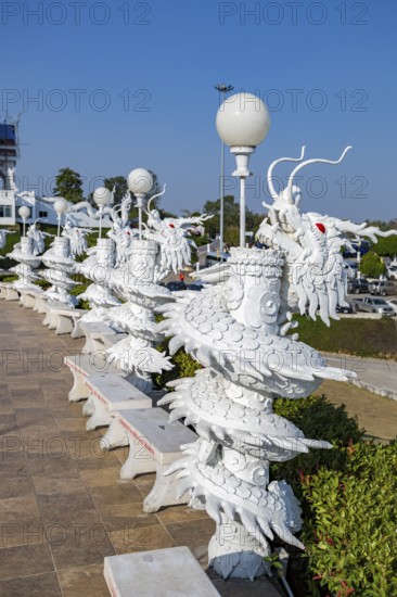 Ornate dragon sculptures around the perimeter of the Guan Yin (Goddess of Mercy) statue at Wat Huay Pla Kang Temple in Chiang Rai province of Northern Thailand