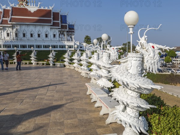 Ornate dragon sculptures around the perimeter of the Guan Yin (Goddess of Mercy) statue at Wat Huay Pla Kang Temple in Chiang Rai province of Northern Thailand
