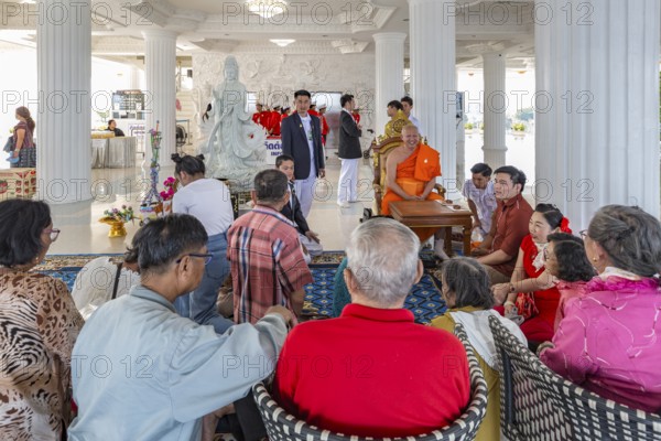 Visitors with monk at the Guan Yin (Goddess of Mercy) statue at Wat Huay Pla Kang Temple in Chiang Rai province of Northern Thailand
