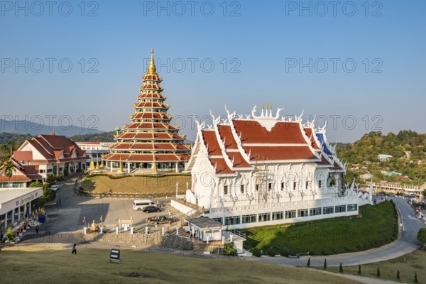 Nine tiered pagoda and viharn assembly hall at Wat Huay Pla Kang in Chiang Rai, Thailand