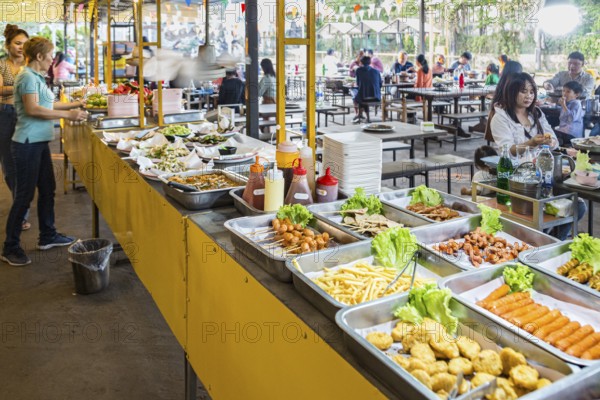 Selection of prepared foods available for customers at a buffet style outdoor restaurant in Chiang Rai province of Northern Thailand