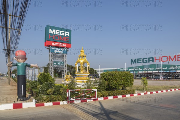 Buddahist shrine outside of the Mega Home building materials warehouse store in Chiang Rai province of Northern Thailand