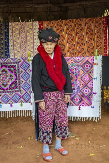 Traditionally dressed woman selling hand woven items in the Lu Mien-Yao tribe area of the Union of Hill Tribe Villages outside of Chiang Rai in the Nanglae District of Thailand