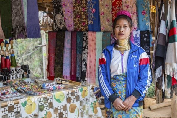 Tribal woman selling woven scarves and other crafts in the Long Neck Karen tribe (more properly called the Kayah Lahwi tribe) area of the Union of Hill Tribe Villages outside of Chiang Rai in the Nanglae District of Thailand