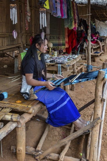 Tribal woman weaving scarves to be sold in the Long Neck Karen tribe (more properly called the Kayah Lahwi tribe) area of the Union of Hill Tribe Villages outside of Chiang Rai in the Nanglae District of Thailand