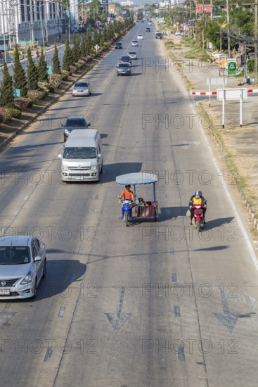 Motor scooter with covered side car driving on the streets of Chiang Rai, Thailand