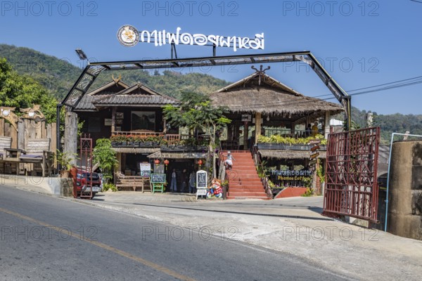 Sign on outdoor bench at the Doi Phamee coffee shop and restaurant in Mae Sai district of Chiang Rai, Thailand