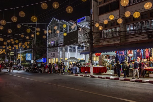 Tourists and locals entering the Night Market in downtown Chiang Rai, Thailand