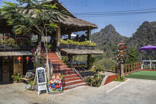Stairs lead up to the dining area and down to the gardens at the Doi Phamee coffee shop and restaurant in Mae Sai district of Chiang Rai, Thailand