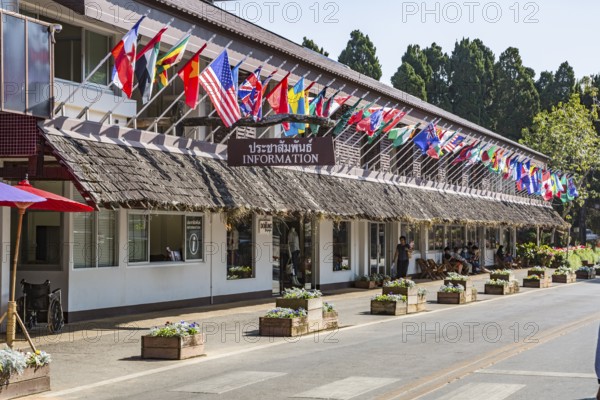 Building with many national flags contains the information center, retail shops and restaurant within the Doi Tung tourist attraction in Chiang Rai, Thailand