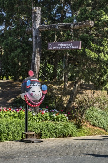 Sign points to the entrance tot he Doi Tung Royal Villa inside the Doi Tung tourist attraction in Chiang Rai, Thailand