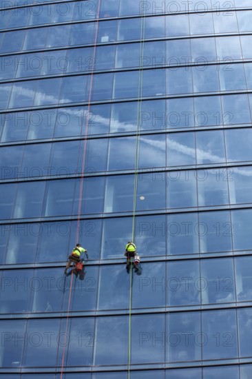 Detroit, Michigan - Window washers at the 25-story Residences Water Square luxury apartment building