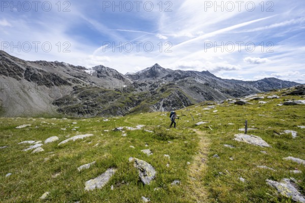 Mountaineer on hiking trail above the Peischachtörl, summit Böses Weibl in the background, Wiener Höhenweg, Schober group, Hohe Tauern National Park, Carinthia, Austria