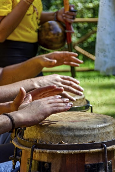 Musicians playing berimbau and atabaque in Brazilian capoeira outdoors, Minas Gerais, Brazil