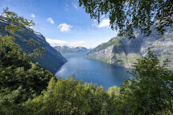 View of the idyllic fjord landscape of the Geirangerfjord at Blomberg Gård, near Geiranger, Møre og Romsdal, Norway