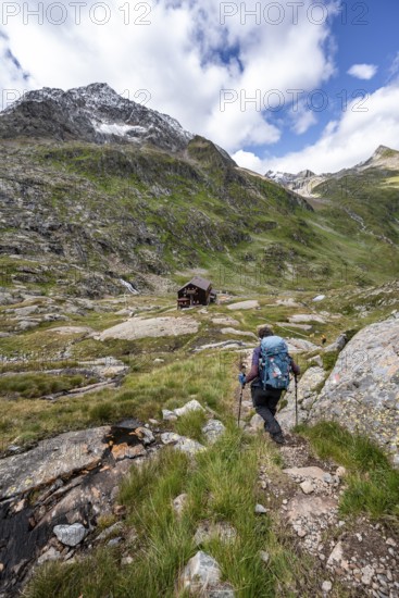 Mountaineer on a hiking trail at the Elberfelderhütte mountain hut in the upper Gössnitztal valley, Wiener Höhenweg, Schober group, Hohe Tauern National Park, Carinthia, Austria