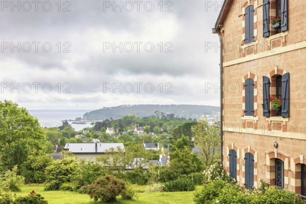 House with a garden and a beautiful sea view on the coast in the summer, Crozon peninsula, Bretagne, France