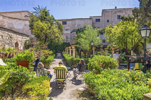 Lush green beautiful garden with visitors at Banys Arabs a historic sites in Palma, Banys Arabs, Palma de Mallorca, Mallorca, Spain