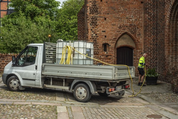 Watering municipal plants from a truck in Ystad, Skåne County, Sweden, Scandinavia