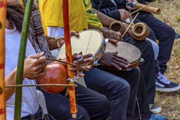 Group of musicians playing berimbau and tambourine in a capoeira performance in Brazil, Minas Gerais, Brazil