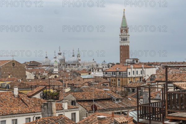 Red tiled roofs, chimneys and church domes dominate the venetian skyline with saint marks campanile rising above the cityscape
