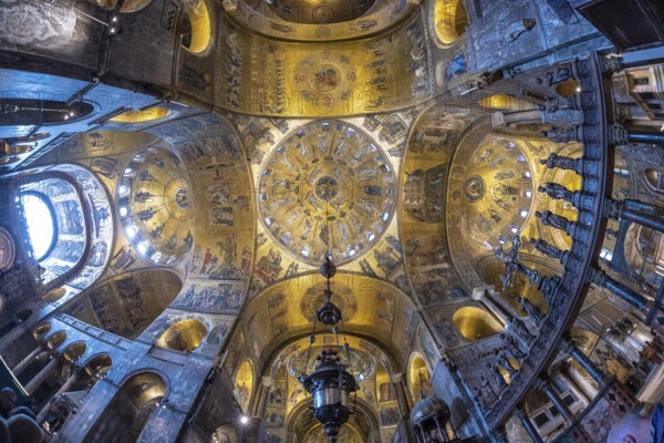 Wide angle view of the richly decorated ceiling of st. Mark's basilica, showcasing its intricate mosaics and byzantine architecture